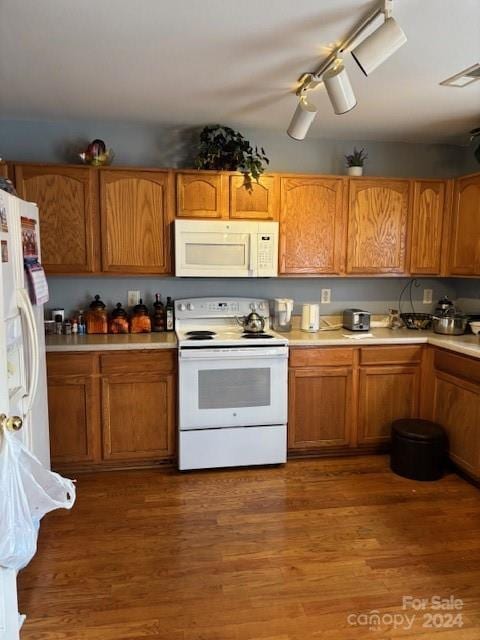 kitchen featuring dark hardwood / wood-style flooring and white appliances