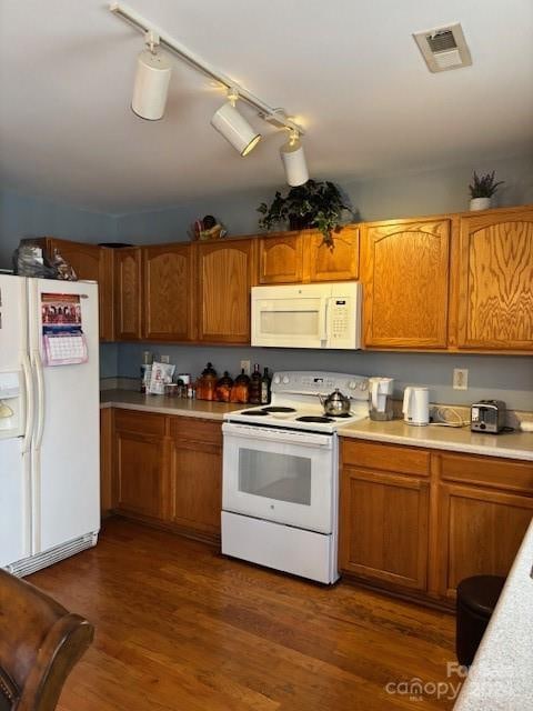 kitchen with dark hardwood / wood-style floors and white appliances