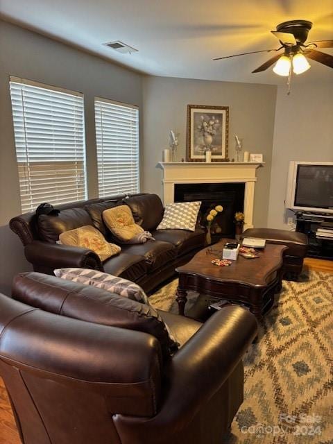 living room featuring ceiling fan and hardwood / wood-style flooring