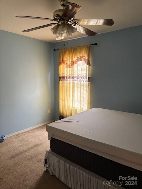 bedroom with ceiling fan and carpet floors