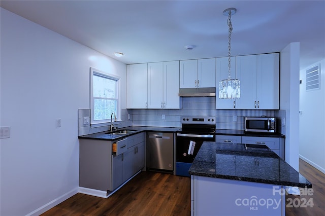 kitchen with white cabinetry, pendant lighting, dark hardwood / wood-style floors, and appliances with stainless steel finishes