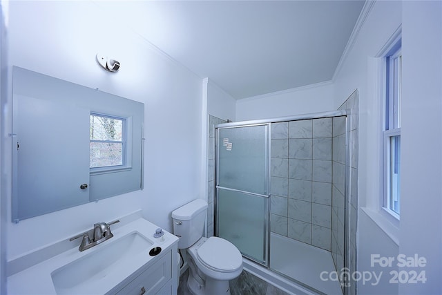 bathroom featuring walk in shower, crown molding, vanity, and toilet