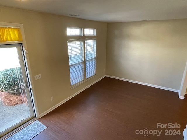 unfurnished room featuring dark hardwood / wood-style floors