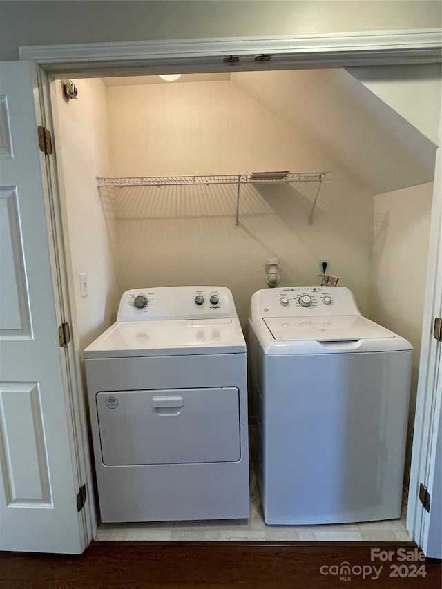 clothes washing area with separate washer and dryer