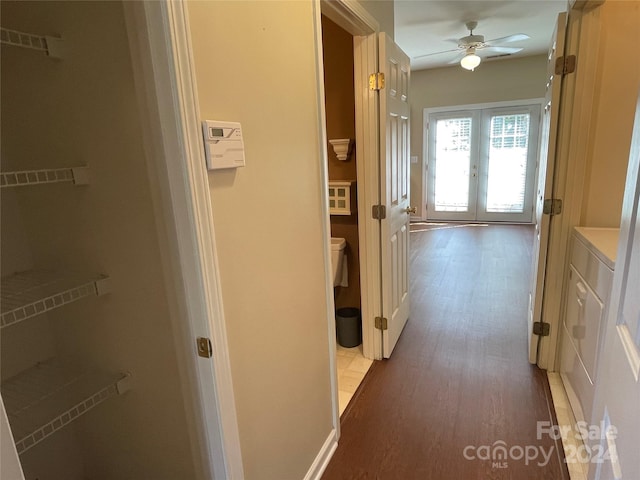 hall with french doors and light hardwood / wood-style flooring