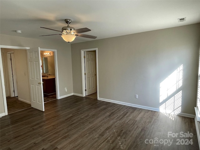 unfurnished bedroom featuring connected bathroom, ceiling fan, and dark hardwood / wood-style floors