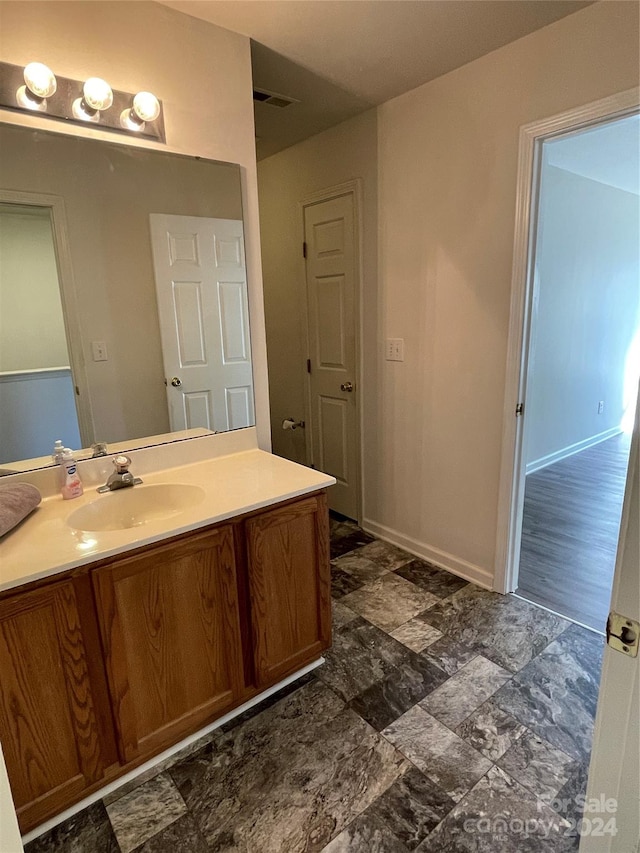 bathroom featuring wood-type flooring and vanity