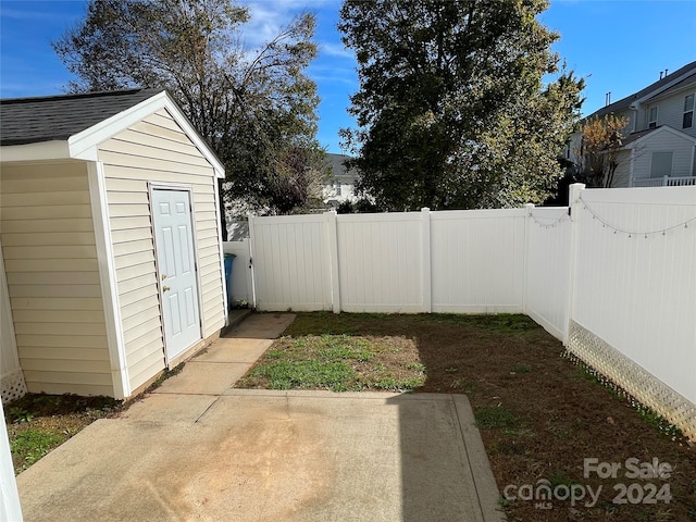 view of yard with a shed and a patio area