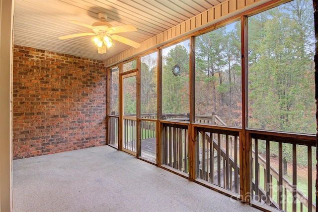 unfurnished sunroom featuring ceiling fan and wood ceiling