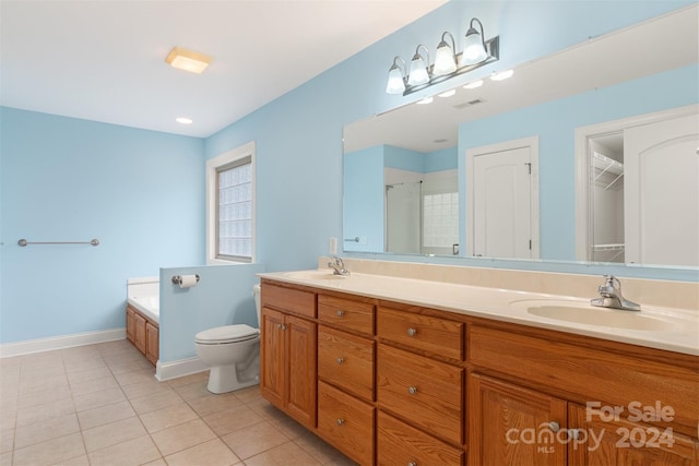 full bathroom with tile patterned flooring, vanity, separate shower and tub, and toilet