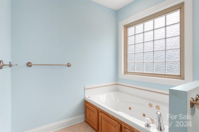 bathroom with tile patterned flooring and a bath