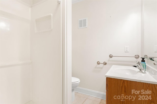 bathroom featuring toilet, vanity, and tile patterned floors