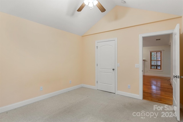 unfurnished bedroom with ceiling fan, light hardwood / wood-style flooring, and lofted ceiling