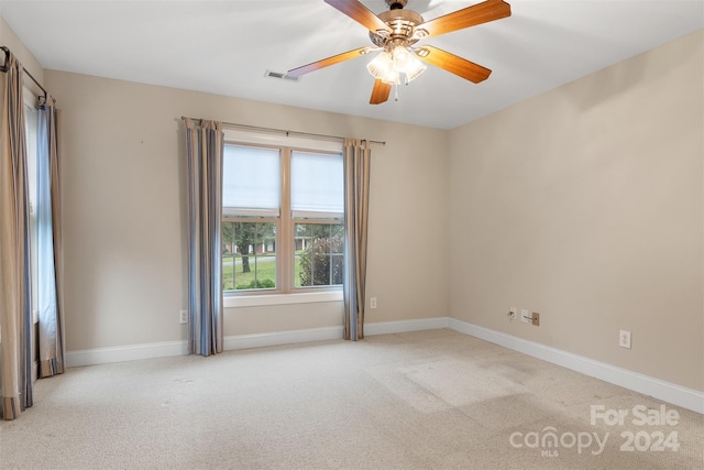 unfurnished room with ceiling fan and light carpet