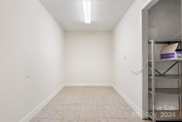 interior space featuring light tile patterned floors and ornamental molding