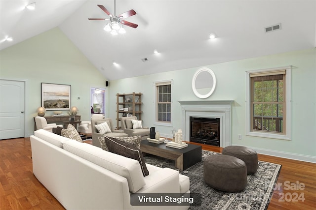 living room with wood-type flooring, high vaulted ceiling, and ceiling fan