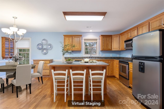 kitchen with plenty of natural light, light hardwood / wood-style floors, and appliances with stainless steel finishes