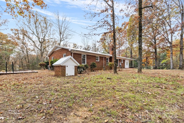 ranch-style home with a storage shed