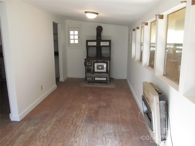 unfurnished living room featuring heating unit, hardwood / wood-style floors, and lofted ceiling