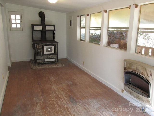 interior space featuring hardwood / wood-style flooring, a healthy amount of sunlight, and heating unit