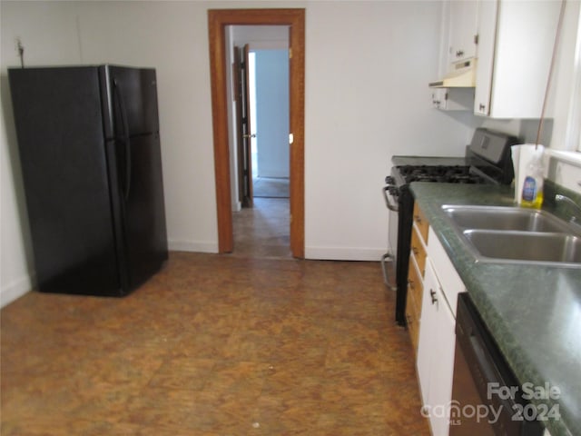 kitchen featuring dishwasher, black fridge, sink, gas range oven, and white cabinetry