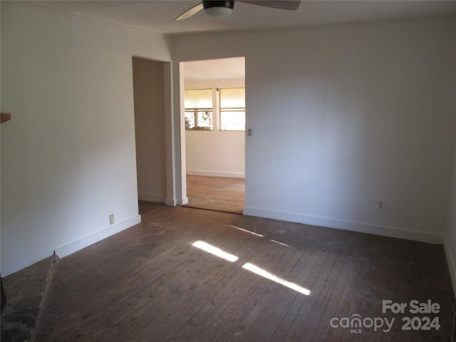 unfurnished room with ceiling fan and dark hardwood / wood-style floors