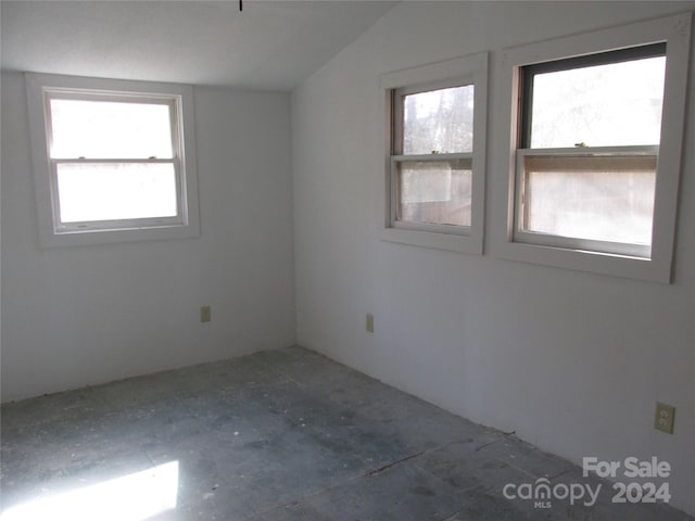 spare room featuring lofted ceiling