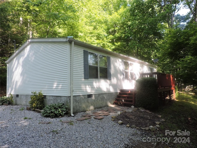 view of side of property featuring a wooden deck