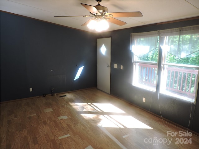 2271 Gouges Creek Rd, Spruce Pine, NC 28777 - spare room with wood finished floors, a ceiling fan, and baseboards