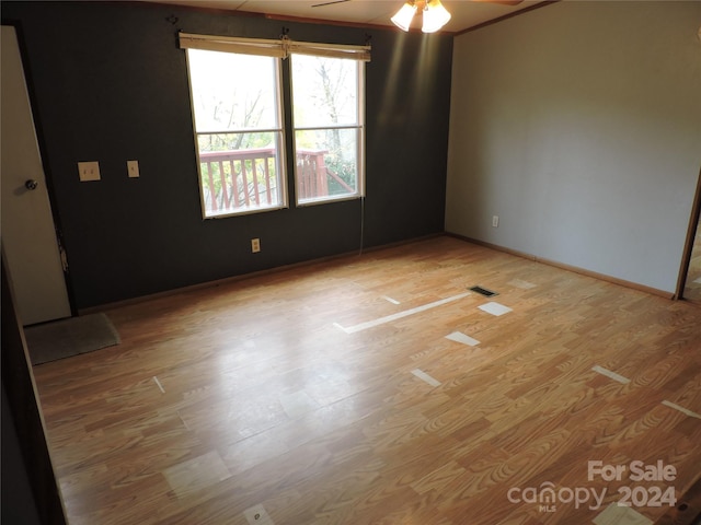 spare room with hardwood / wood-style flooring and ceiling fan