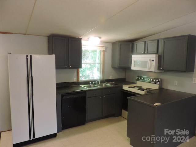 kitchen with lofted ceiling, sink, and white appliances