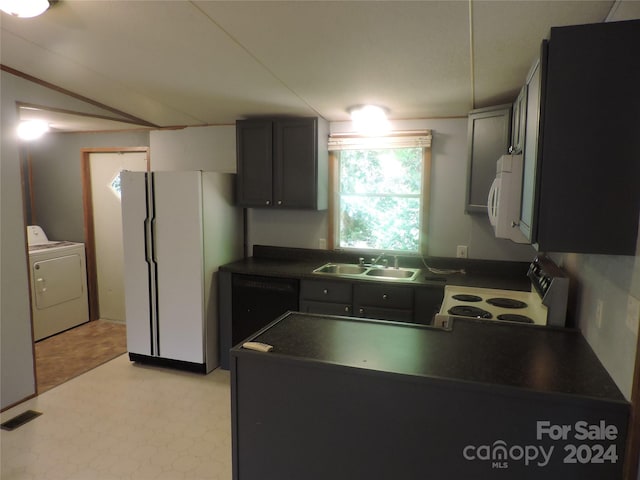 kitchen with washer / dryer, white appliances, and sink