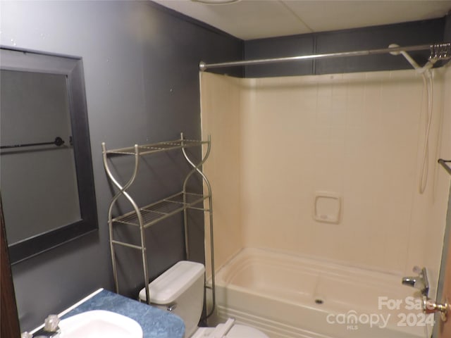 bathroom featuring toilet and bathing tub / shower combination