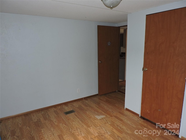 unfurnished room with light wood-type flooring