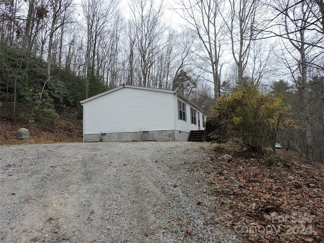 2271 Gouges Creek Rd, Spruce Pine, NC 28777 - view of property exterior featuring crawl space and gravel driveway