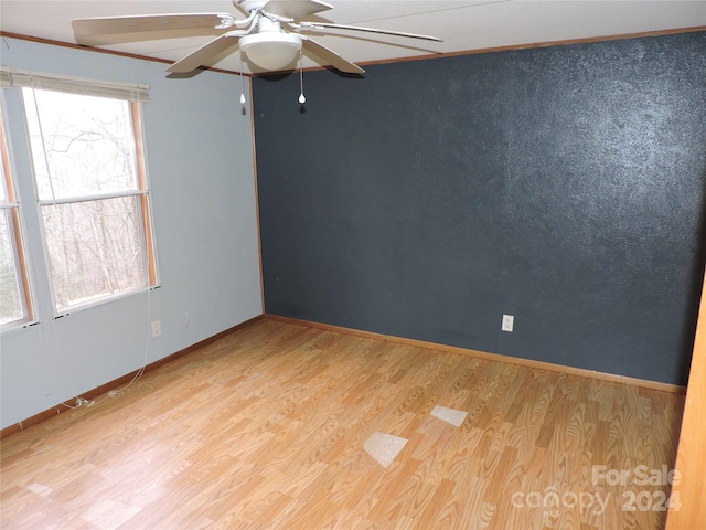 spare room featuring ceiling fan and light hardwood / wood-style flooring