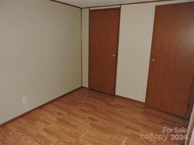 unfurnished bedroom with a closet and light hardwood / wood-style floors