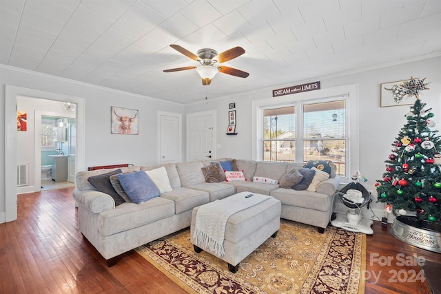 living room featuring hardwood / wood-style floors, ceiling fan, and crown molding