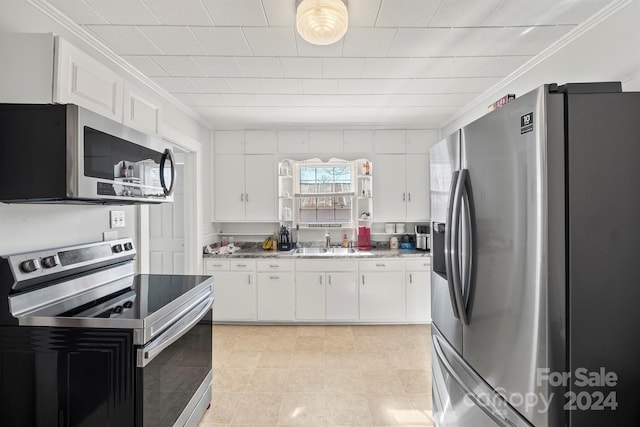 kitchen with white cabinetry, sink, stainless steel appliances, light stone counters, and ornamental molding