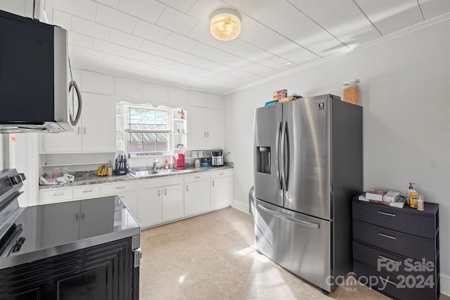 kitchen featuring crown molding, sink, white cabinetry, and stainless steel appliances