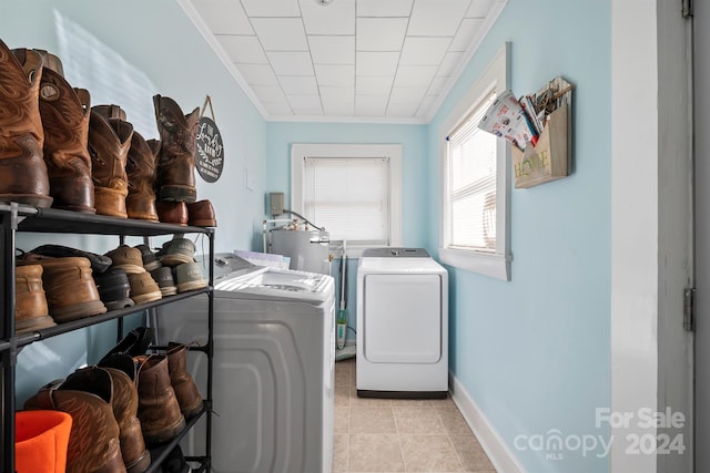 laundry room with washing machine and dryer, electric water heater, ornamental molding, and light tile patterned flooring