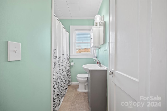 bathroom featuring tile patterned flooring, toilet, vanity, and ornamental molding