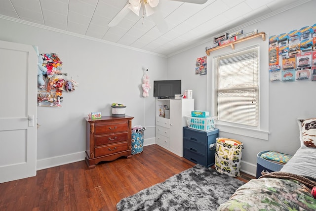 bedroom with ceiling fan, dark hardwood / wood-style flooring, and ornamental molding