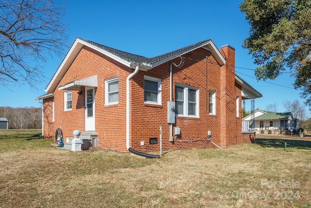 view of home's exterior featuring a lawn