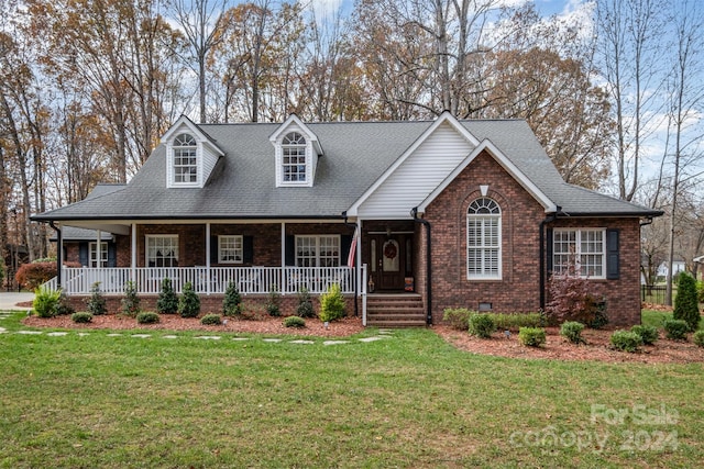 view of front of property with a porch and a front yard