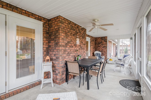 sunroom / solarium featuring ceiling fan