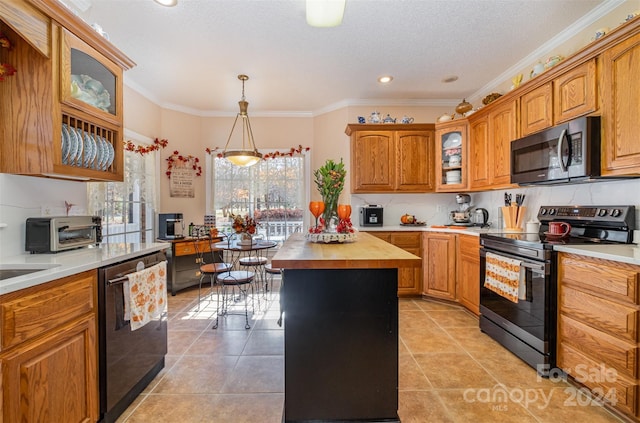 kitchen featuring pendant lighting, wooden counters, crown molding, appliances with stainless steel finishes, and a kitchen island