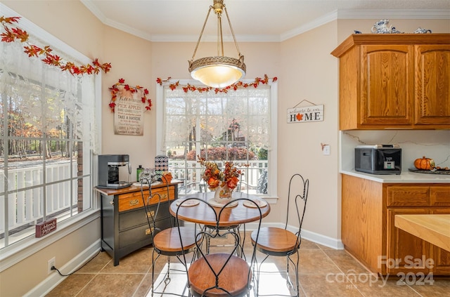 dining area with light tile patterned floors and crown molding