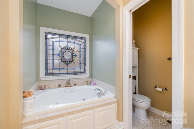 bathroom with tile patterned flooring, toilet, and a bath