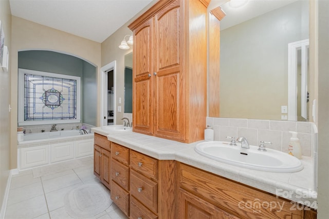 bathroom with tile patterned floors, vanity, and a bathing tub